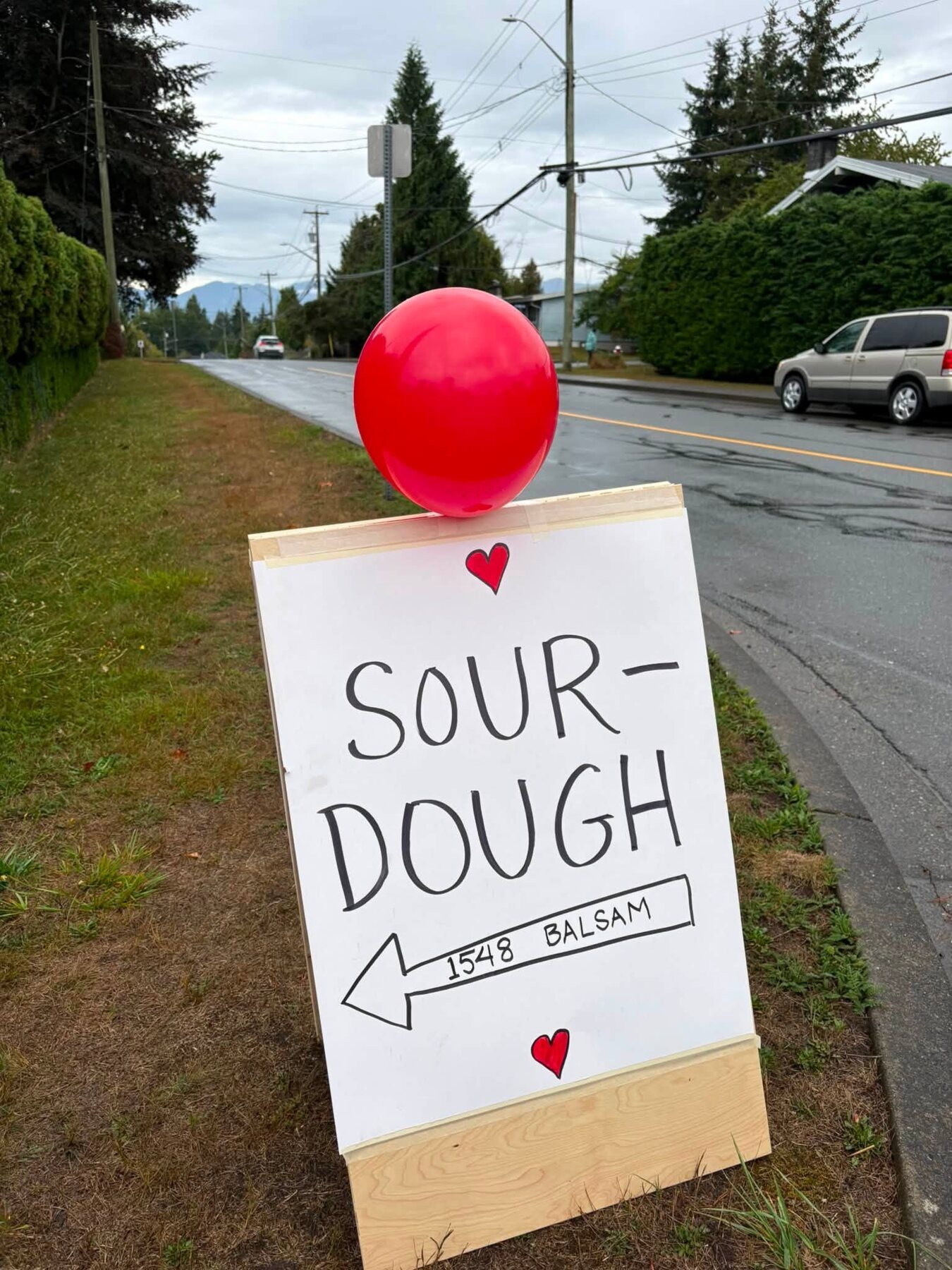Roadside sign pointing toward fresh sourdough